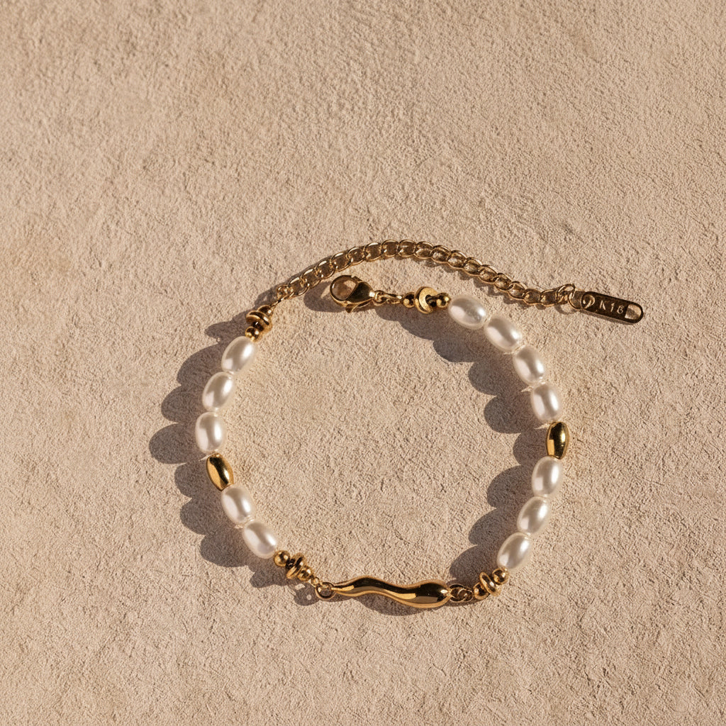 Realistic flat lay photograph of the premium gold molten bar pearl bracelet resting on textured cream linen under crisp, natural sunlight.