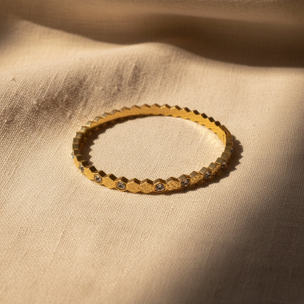 Detailed shot of the high-quality gold plating and the secure integrated box clasp on the geometric stone bangle.