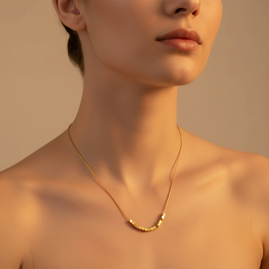 Detailed shot of the high-quality 18K gold plating and secure lobster clasp with adjustable chain links.
