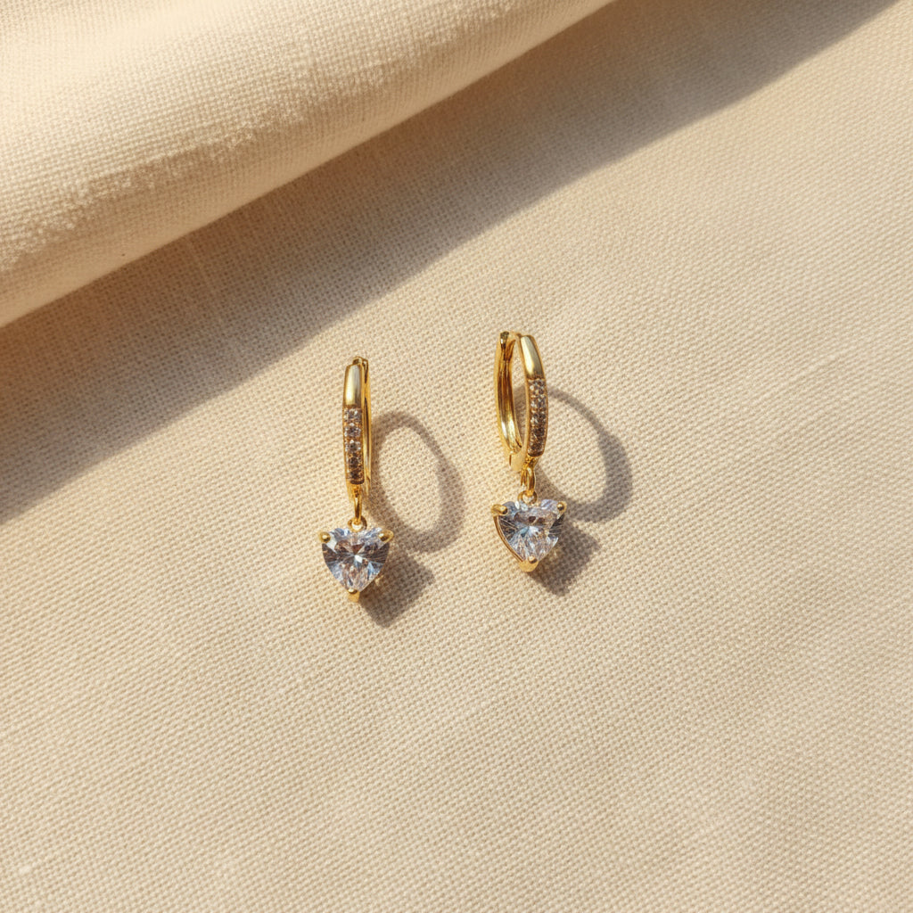 Detailed shot of the secure lever back closure and the high-quality 18K gold plating of the heart hoops.