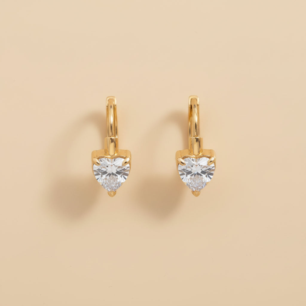 Close-up of the secure latch back closure and the high-quality gold plating on the heart charm hoops.