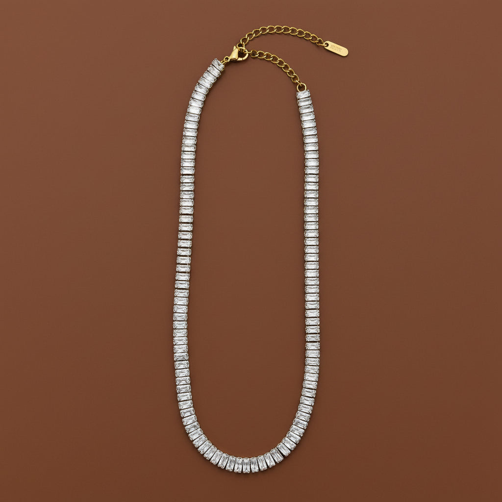 A model wearing the Rusty Gold Tennis Necklace to showcase its unique vintage glow and elegant draping on the neck.