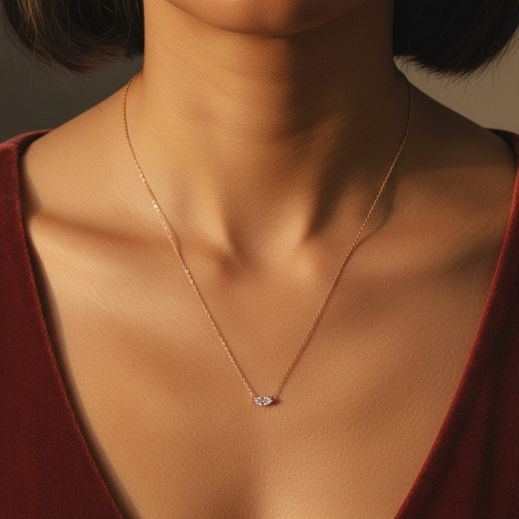A detailed, realistic photograph focusing on a woman's neck, wearing the 18K gold plated starburst necklace under warm golden lighting against a solid deep cocoa brown background.
