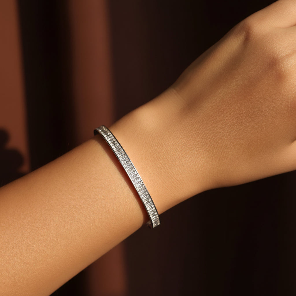 Crystal Gold Bangle Bracelet on wrist against dark background – stackable bangle