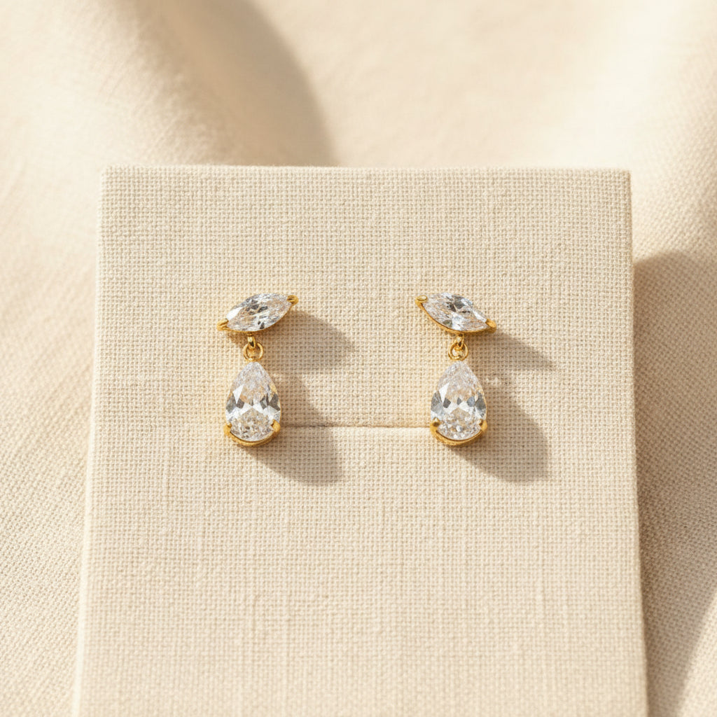Crystal Teardrop Elegance Earrings close-up of teardrop crystal stone reflecting light in gold plated setting
