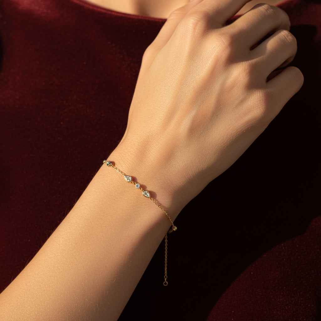 A close-up view of the Delicate Teardrop Crystal Bracelet highlighting the sparkling pear-cut stone and fine gold chain.