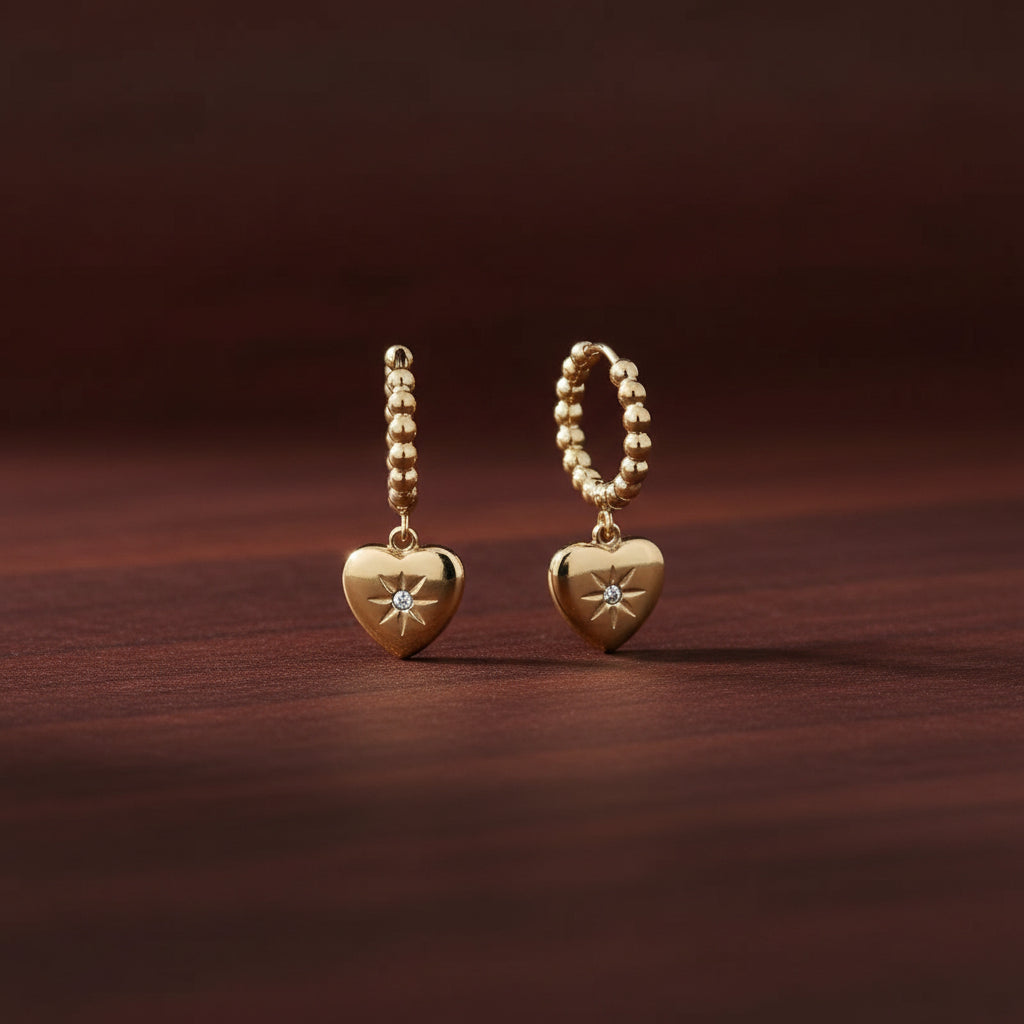 Dual Heart Charm Hoop Earrings close-up of dual heart cubic zirconia charms in gold plated setting