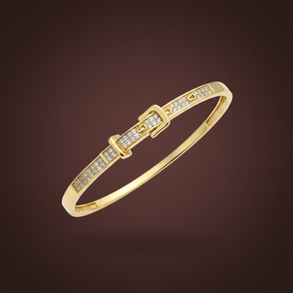 A professional high-angle catalogue shot of the gold plated belt buckle crystal oval kada bangle in standard size, isolated with simple shadows on a rich #5b3b3a brown background, as seen in image_64d866.jpg.