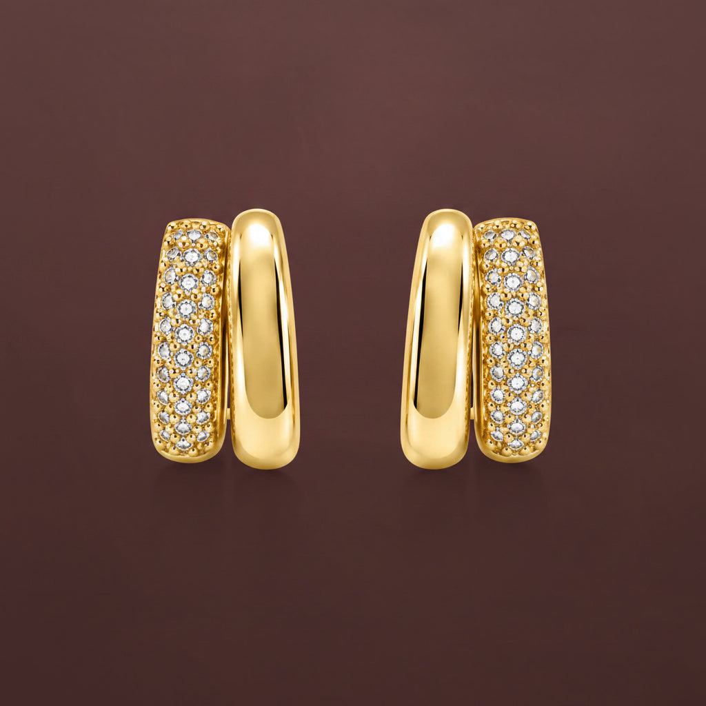 A professional flat lay catalogue shot of the gold plated layered double hoop crystal huggie earrings with simple shadows on a rich #5b3b3a brown background.
