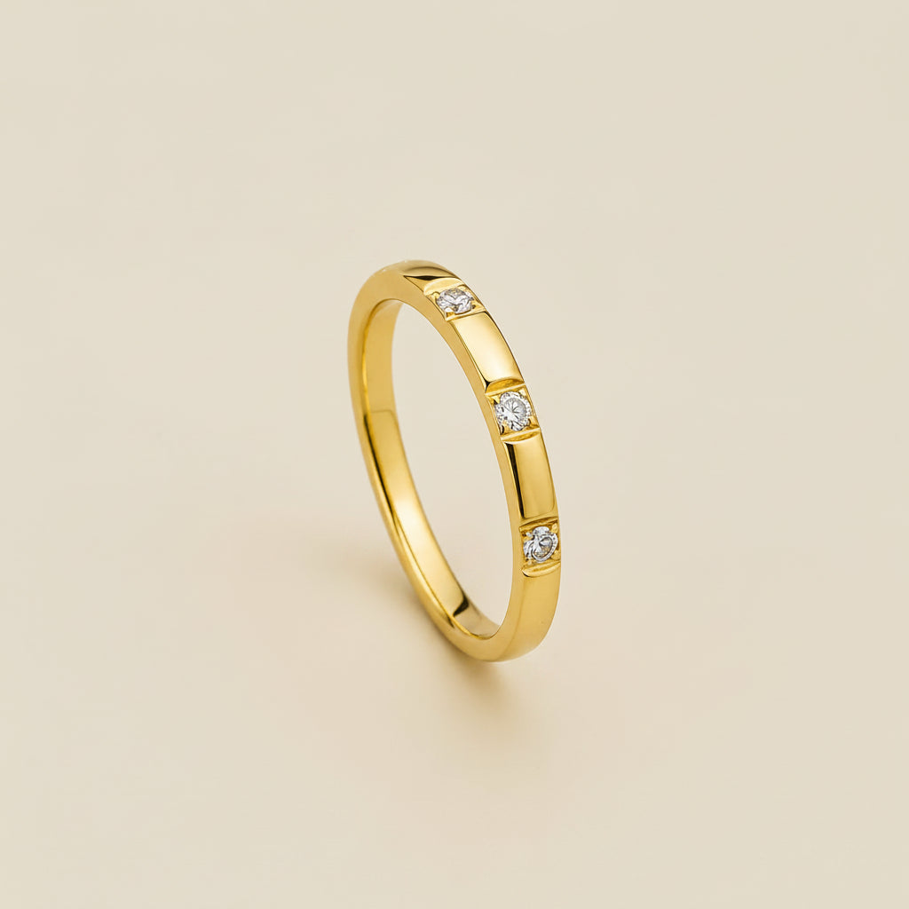 A professional standing catalogue view of the 18K gold plated minimalist triple stone flat-edge ring with crisp square bezel settings, with simple shadows on a clean white background.