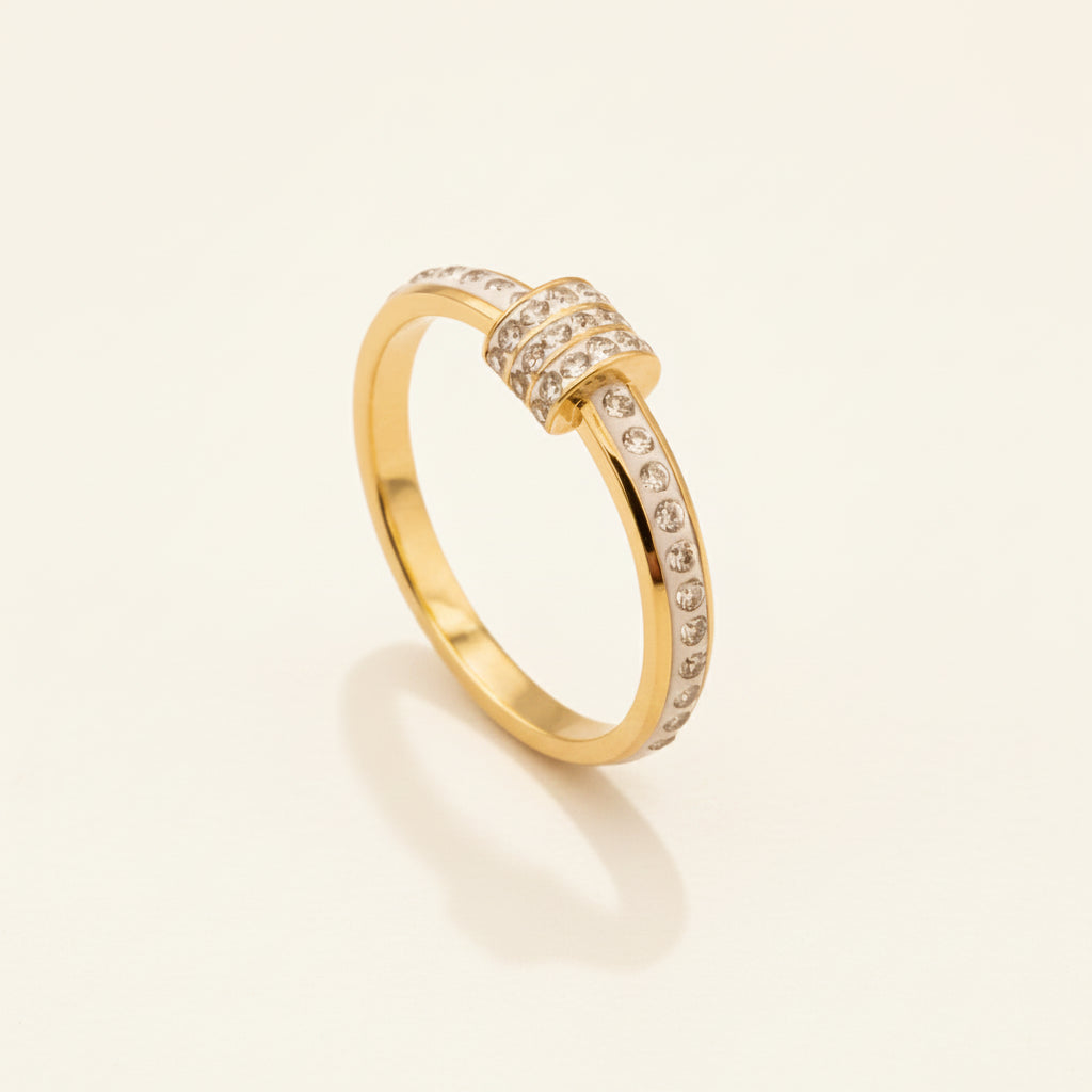 gold-white-enamel-stackable-crystal-knot-ring-standing-cream-background