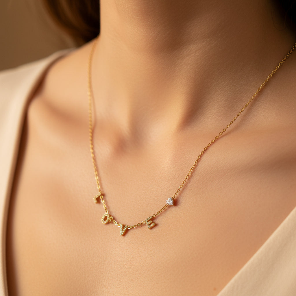 Love Luxe Necklace front view showing crystal-studded LOVE letters in gold plated finish