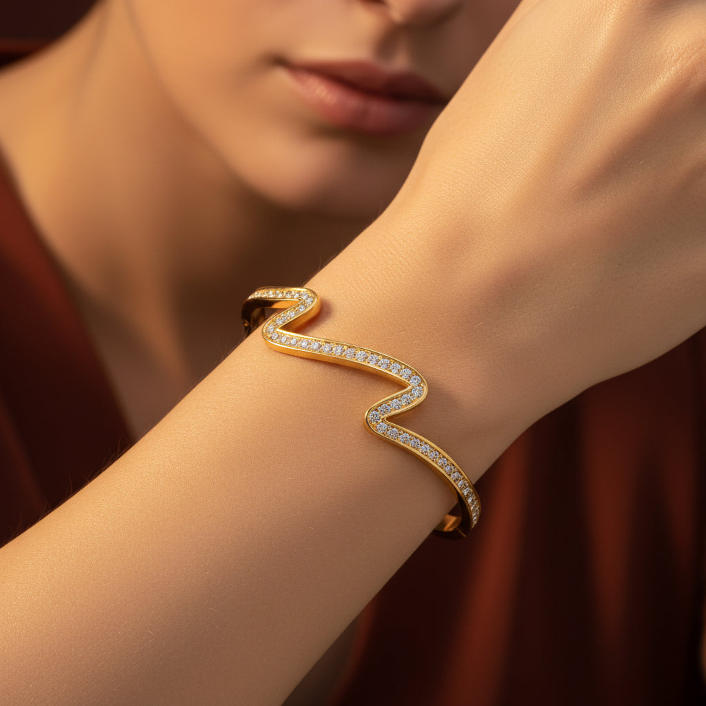 A model's wrist wearing the Aurielle Crystal Wave Bangle to showcase its fluid silhouette and radiant shimmer.