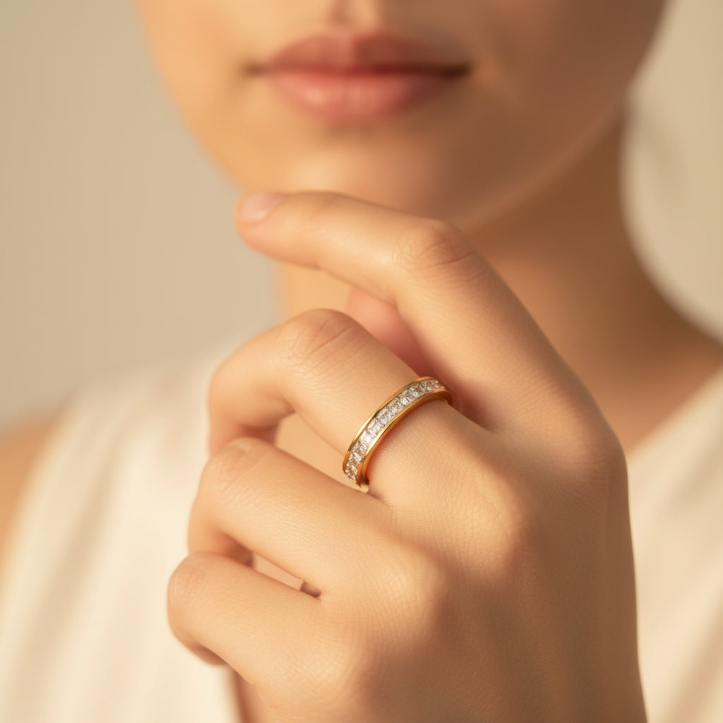 A model wearing the Eterna Crystal Band Ring as part of a gold ring stack to showcase its radiant shimmer and slim profile.