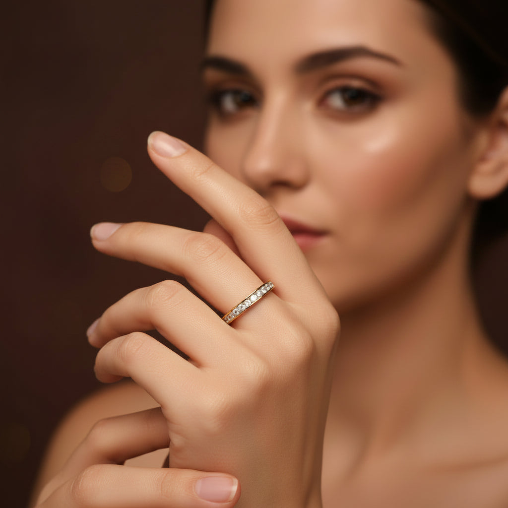 A model wearing the Eterna Crystal Band Ring as part of a gold ring stack to showcase its radiant shimmer and slim profile.