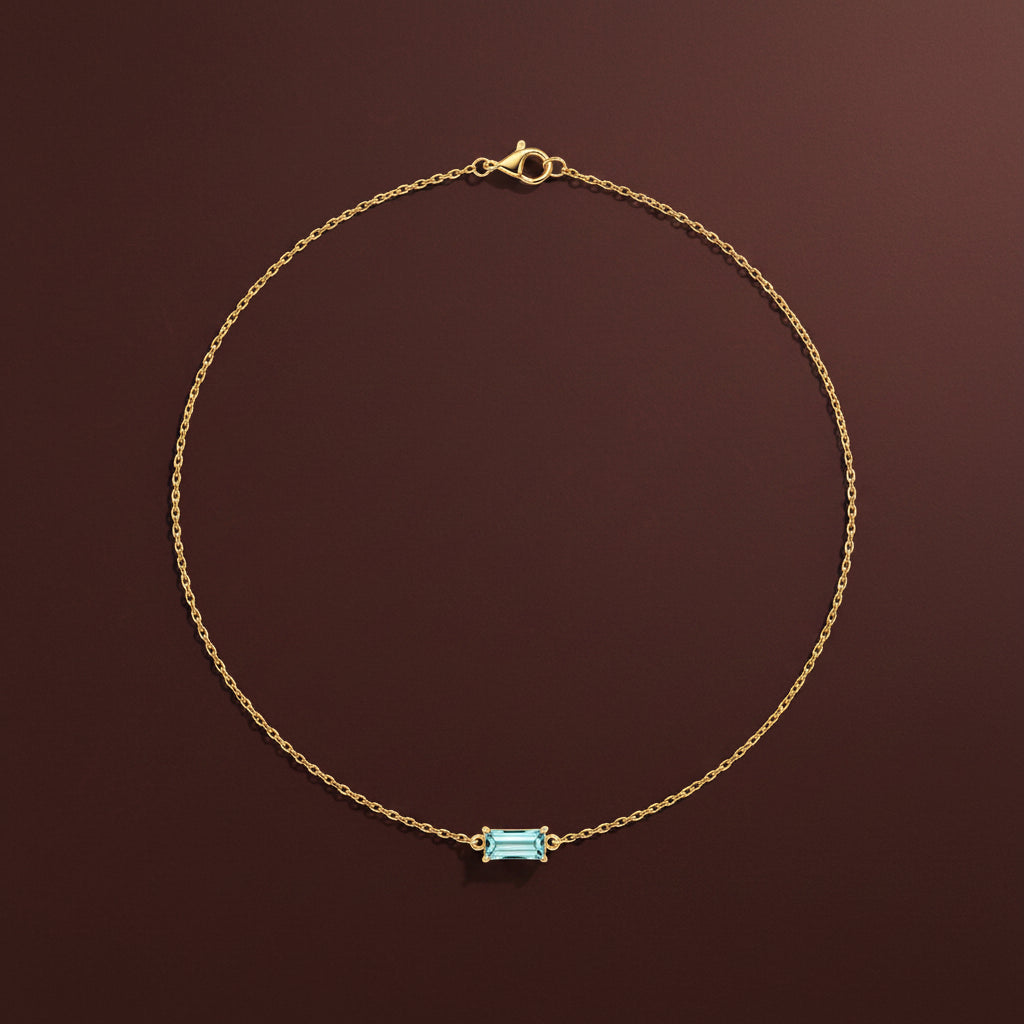 18K gold plated blue crystal pendant necklace on a luxury catalogue background.