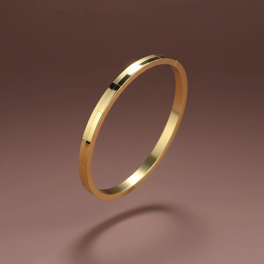 A professional high-angle catalogue shot of the gold plated brick textured oval kada bangle, sized specifically for thin wrists, isolated on a deep cocoa brown background with simple shadows, as seen in image_dab783.jpg.
