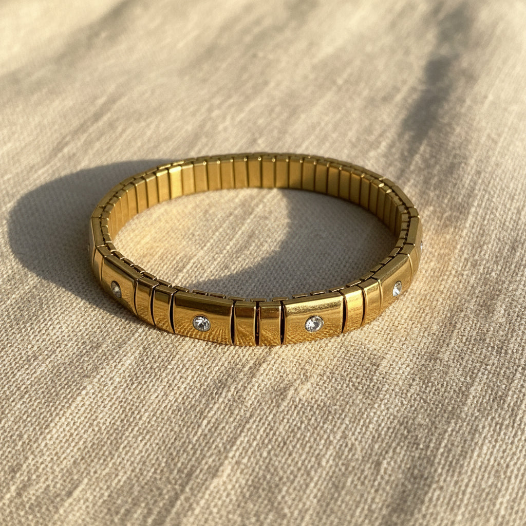 A close-up view of the Celestia Glissade Bracelet highlighting the flexible gold setting and continuous line of brilliant crystals.