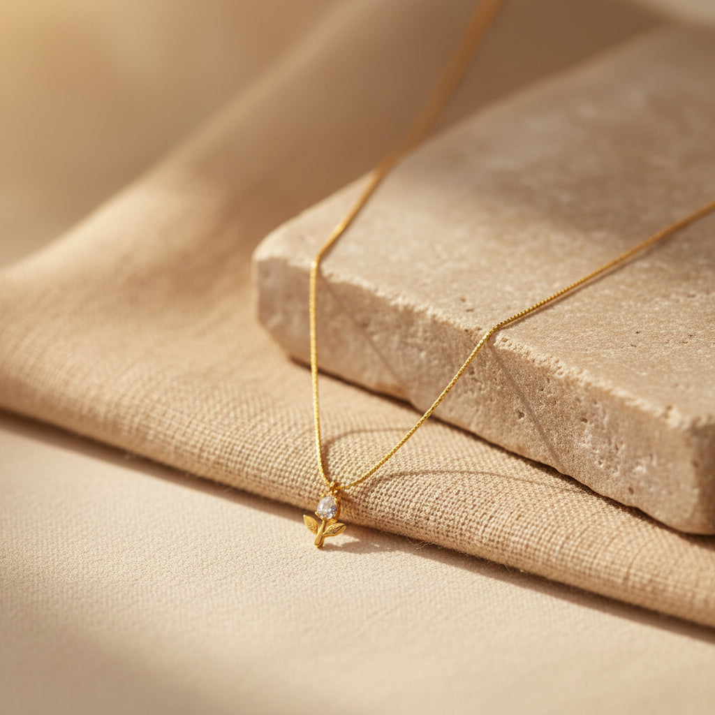 Detailed shot of the high-quality 18K gold plating and the secure lobster clasp of the floral pendant necklace.