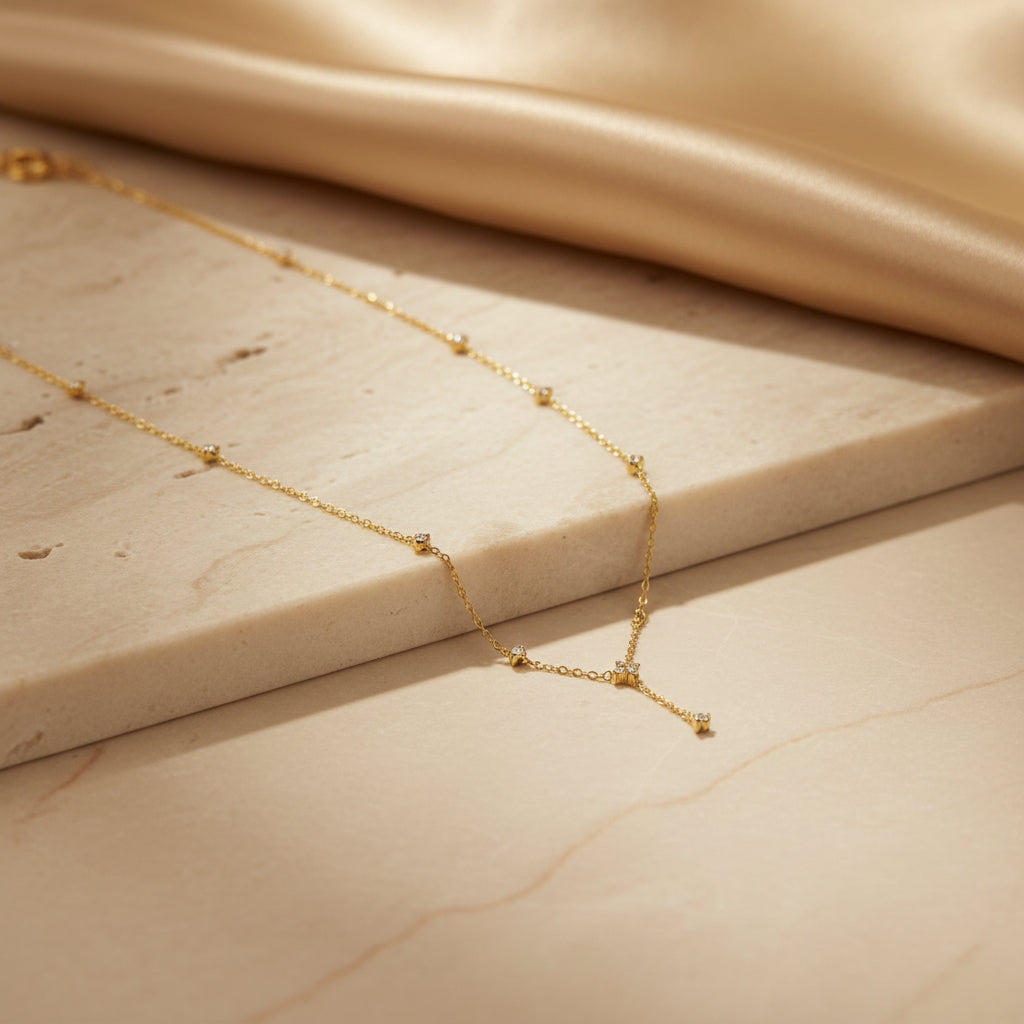 Detailed shot of the high-quality 18K gold plating and the secure lobster clasp on the elegant drop charm necklace.