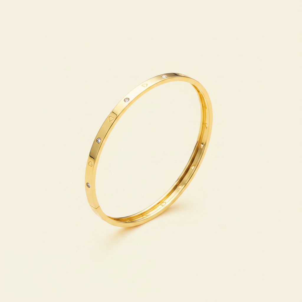 Detailed shot of the high-quality 18K gold plating and the secure, hidden side-lock mechanism on the Luna Heart bangle.