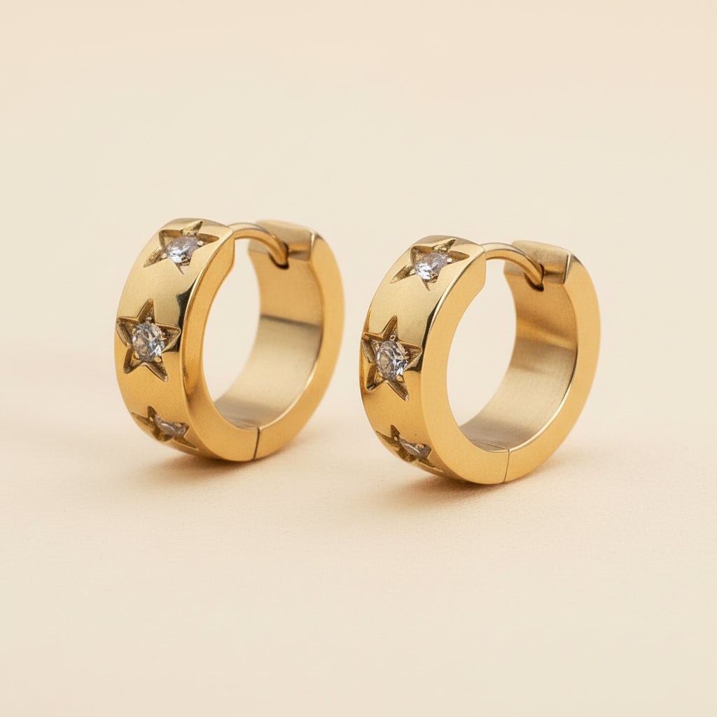 Detailed close-up of the secure latch back closure and the 18K gold plating on the star charm hoops.