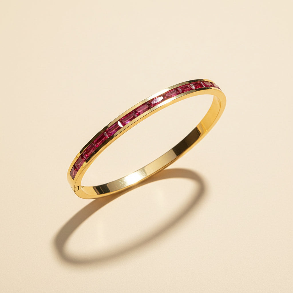 Detailed shot of the high-quality gold plating and the secure side-lock mechanism on the ruby line bangle.