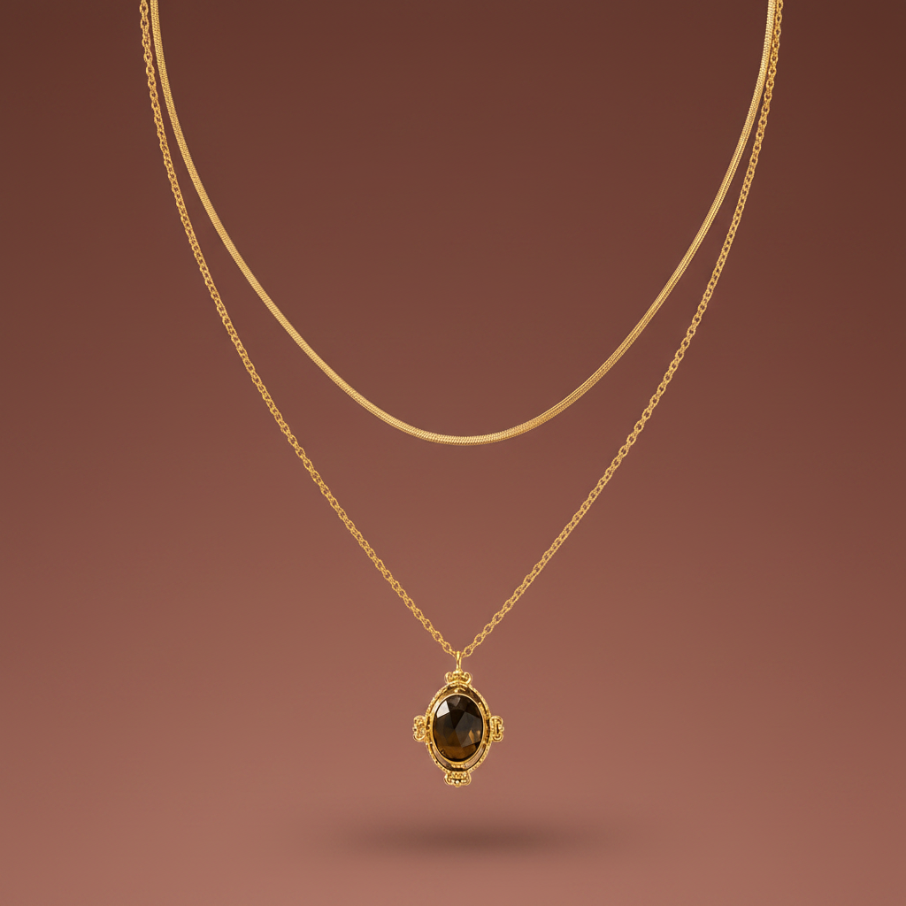 Layered gold necklace with snake chain and vintage pendant on a #5b3b3a luxury catalogue background.