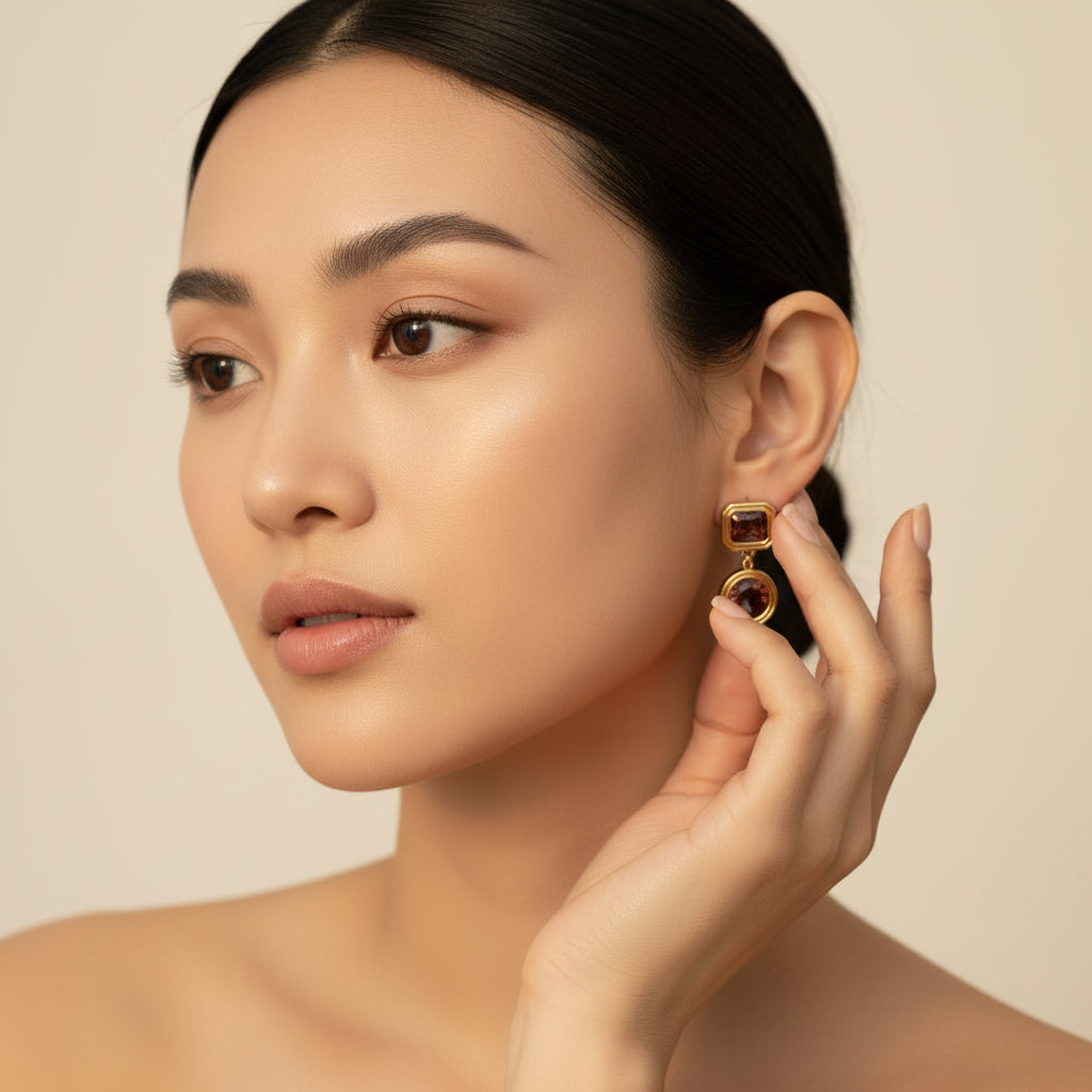 Elegant model wearing Celeste Champagne Drop Earrings against a premium cream background.