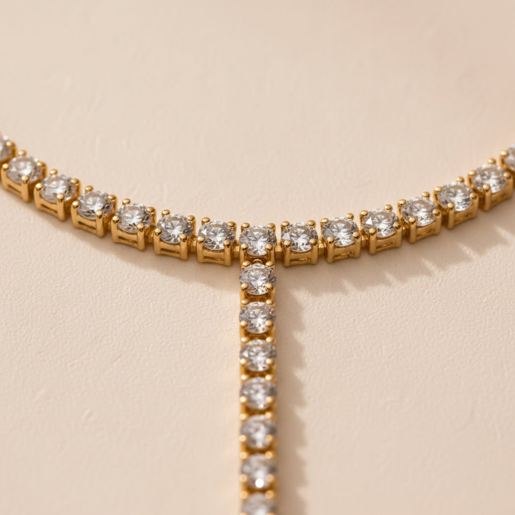 Gold tennis hand chain styled on cream linen with luxury jewellery accessories.