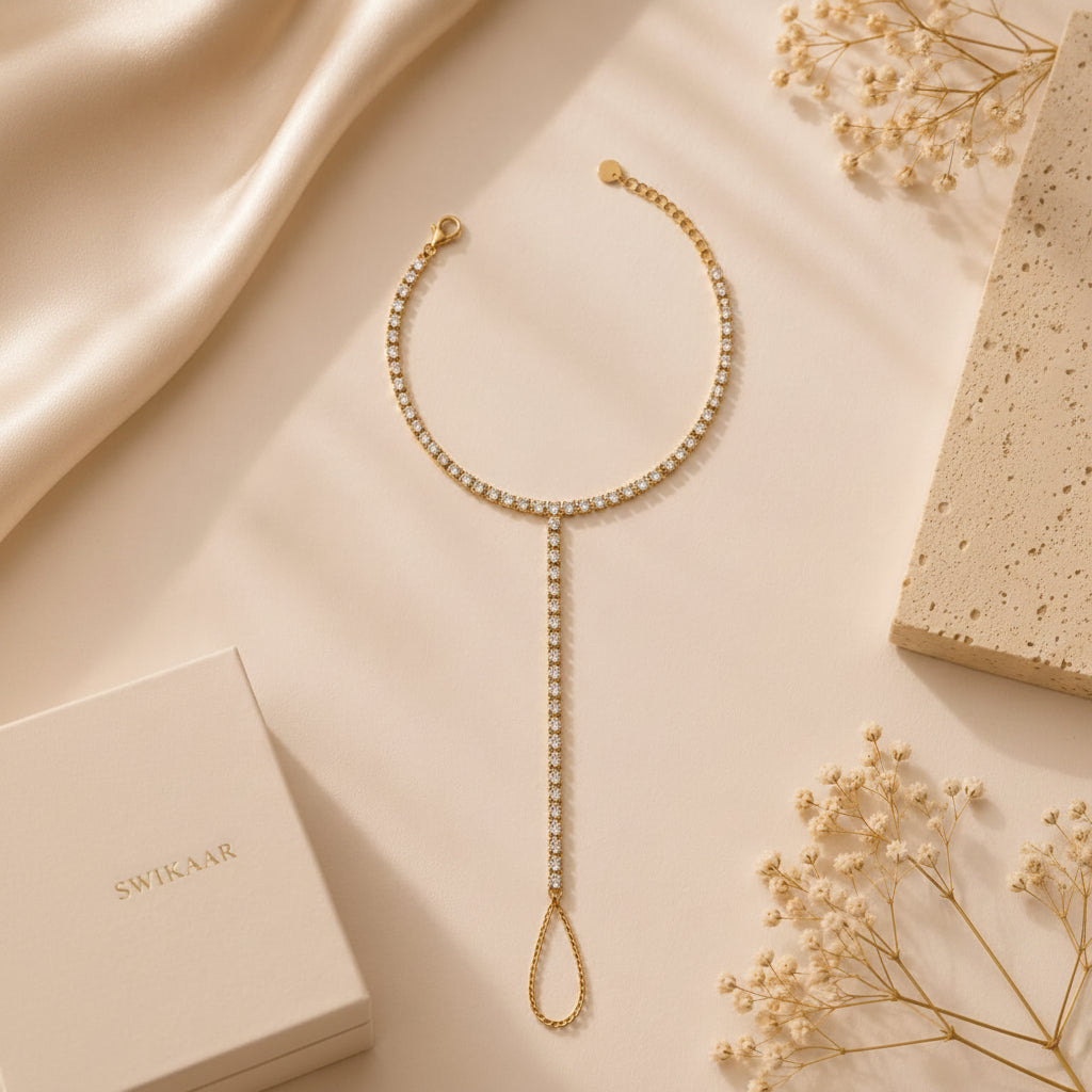 Elegant gold tennis hand chain worn naturally on a woman's hand.