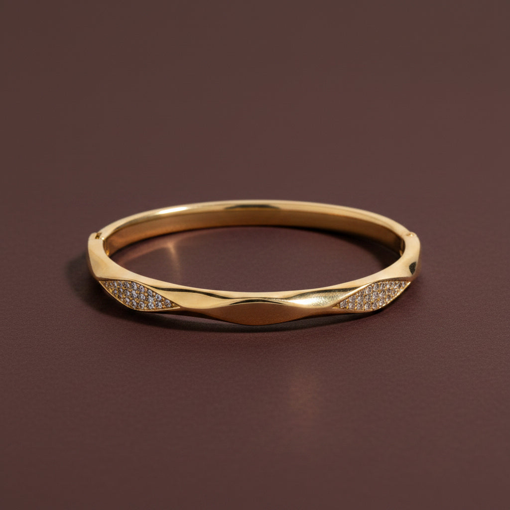 A close-up view of the Celestia Twist Crystal Bangle highlighting the interlocking gold and crystal bands.