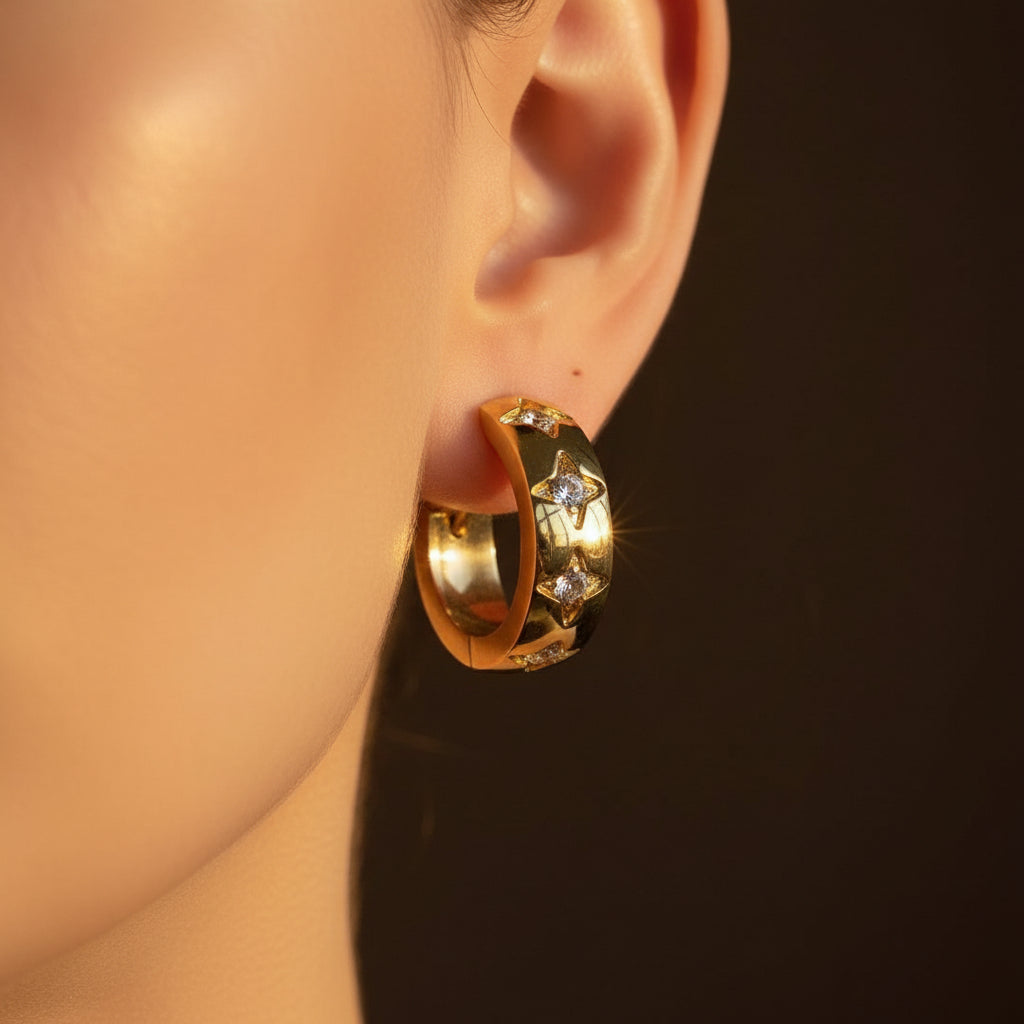 A model wearing the Star Crystal Hoop Earrings to showcase their size, sparkle, and how they sit on the ear.