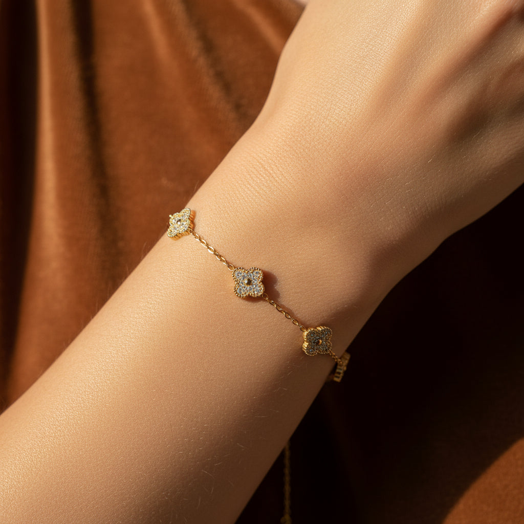 Clover Luxe Charm Bracelet close-up showing dangling four-leaf clover charm detail