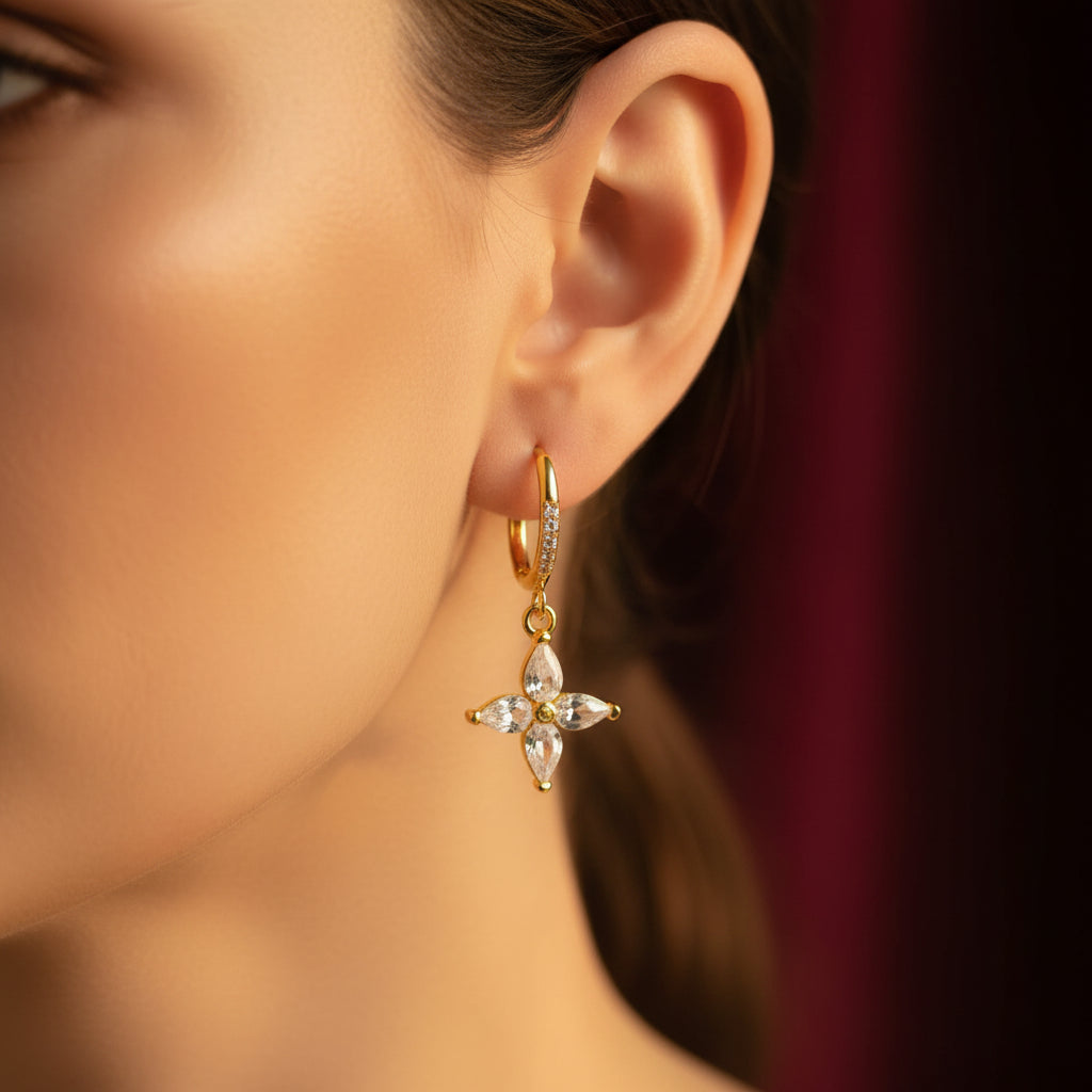 Crystal Bloom Charm Hoop Earrings pair flat lay – gold crystal flower drop earrings by Swikaar