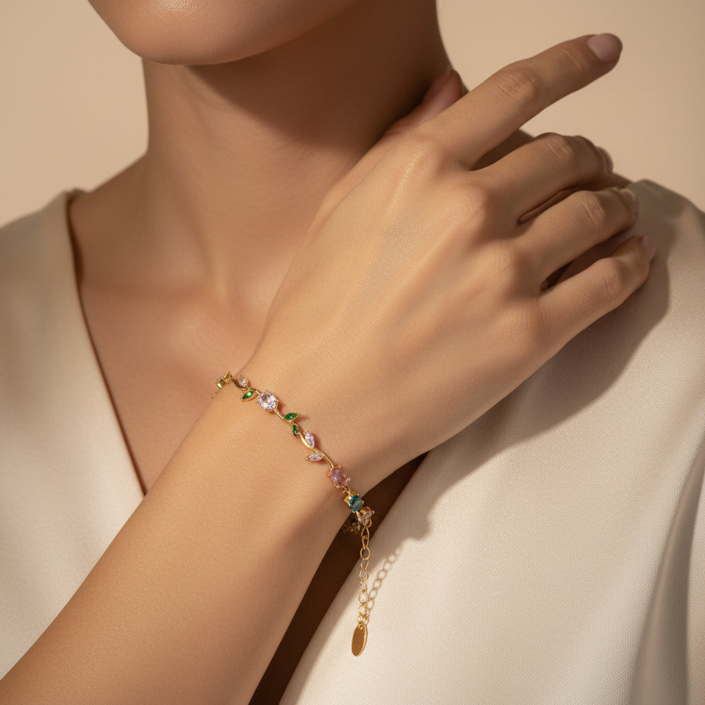 Delicate gold bracelet with gemstones on a maroon background