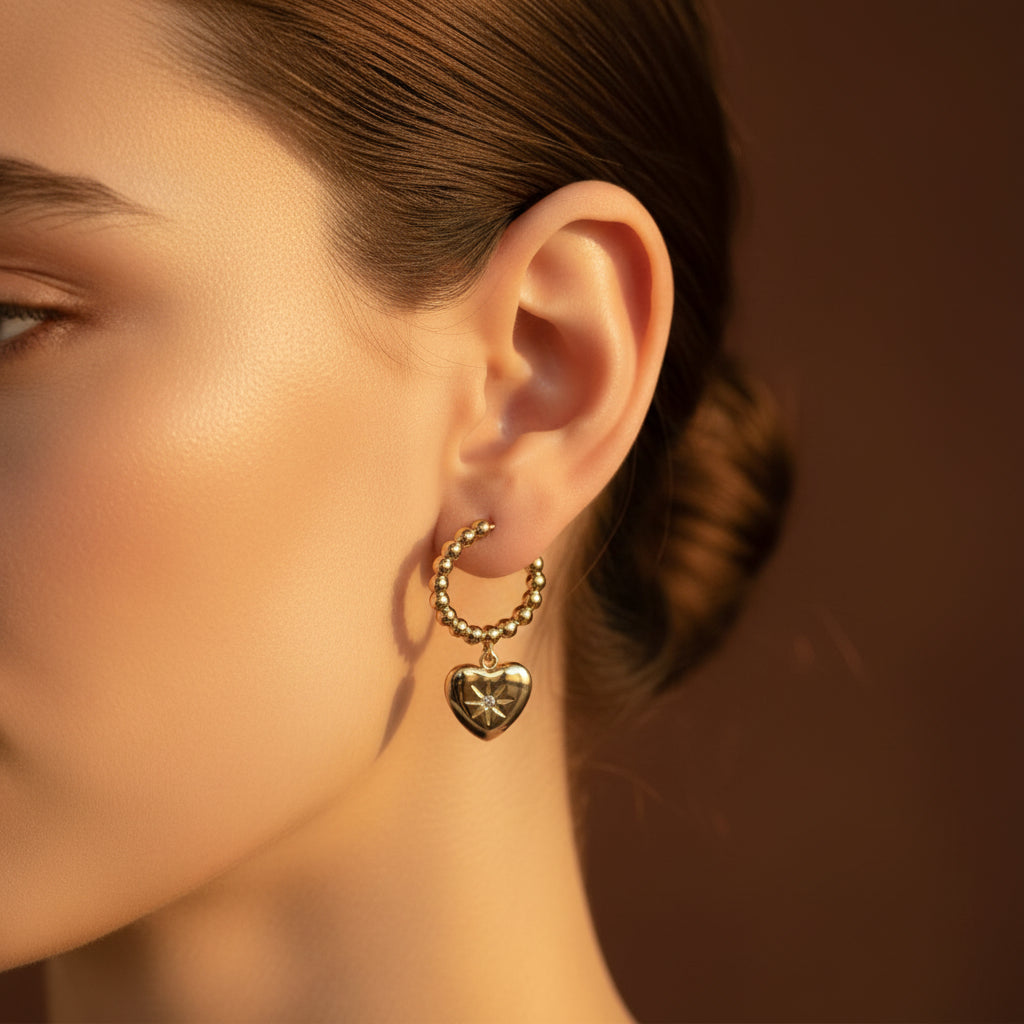 Dual Heart Charm Hoop Earrings front view showing two sparkling heart crystal charms on gold hoop