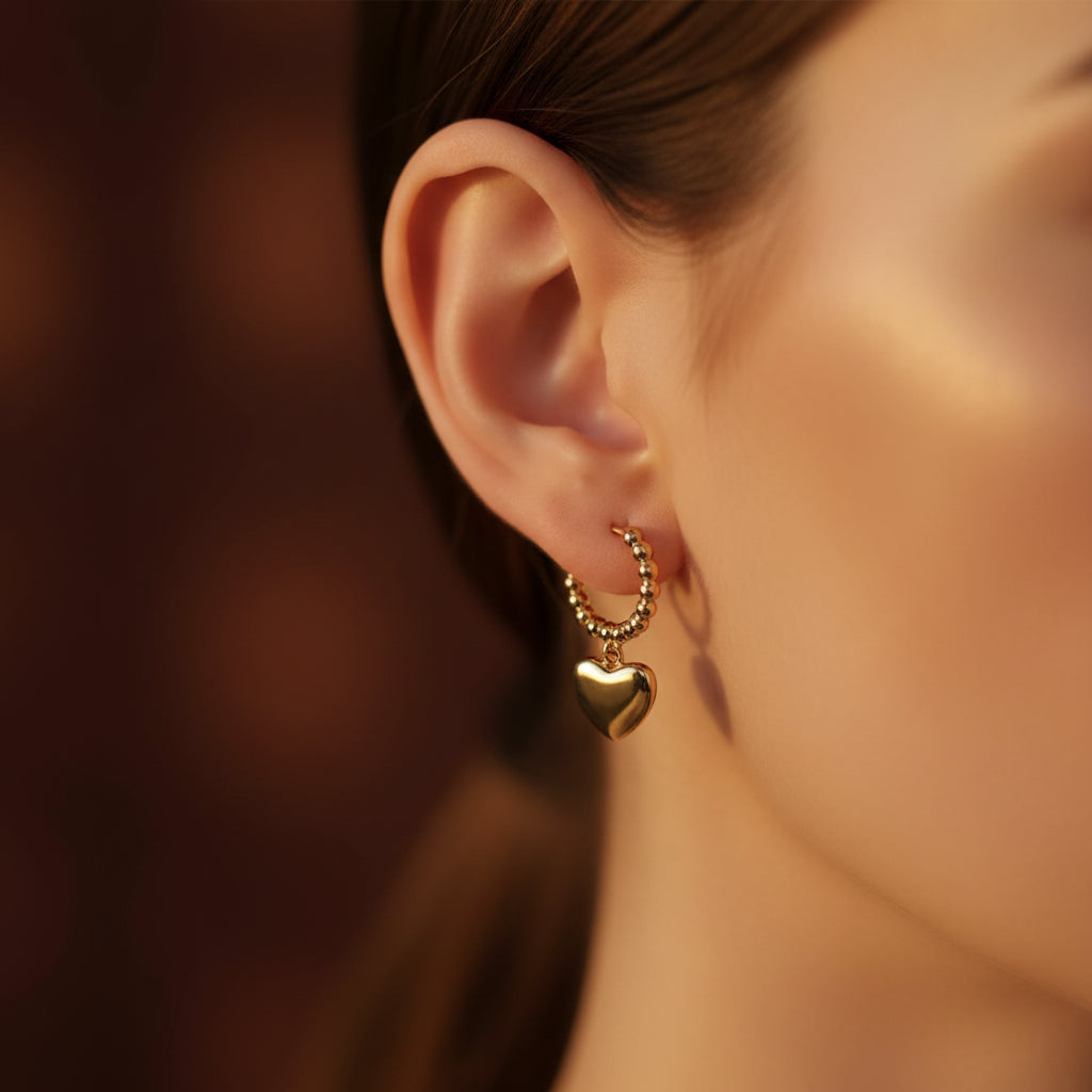 Dual Heart Charm Hoop Earrings pair flat lay – gold plated heart charm hoop earrings by Swikaar