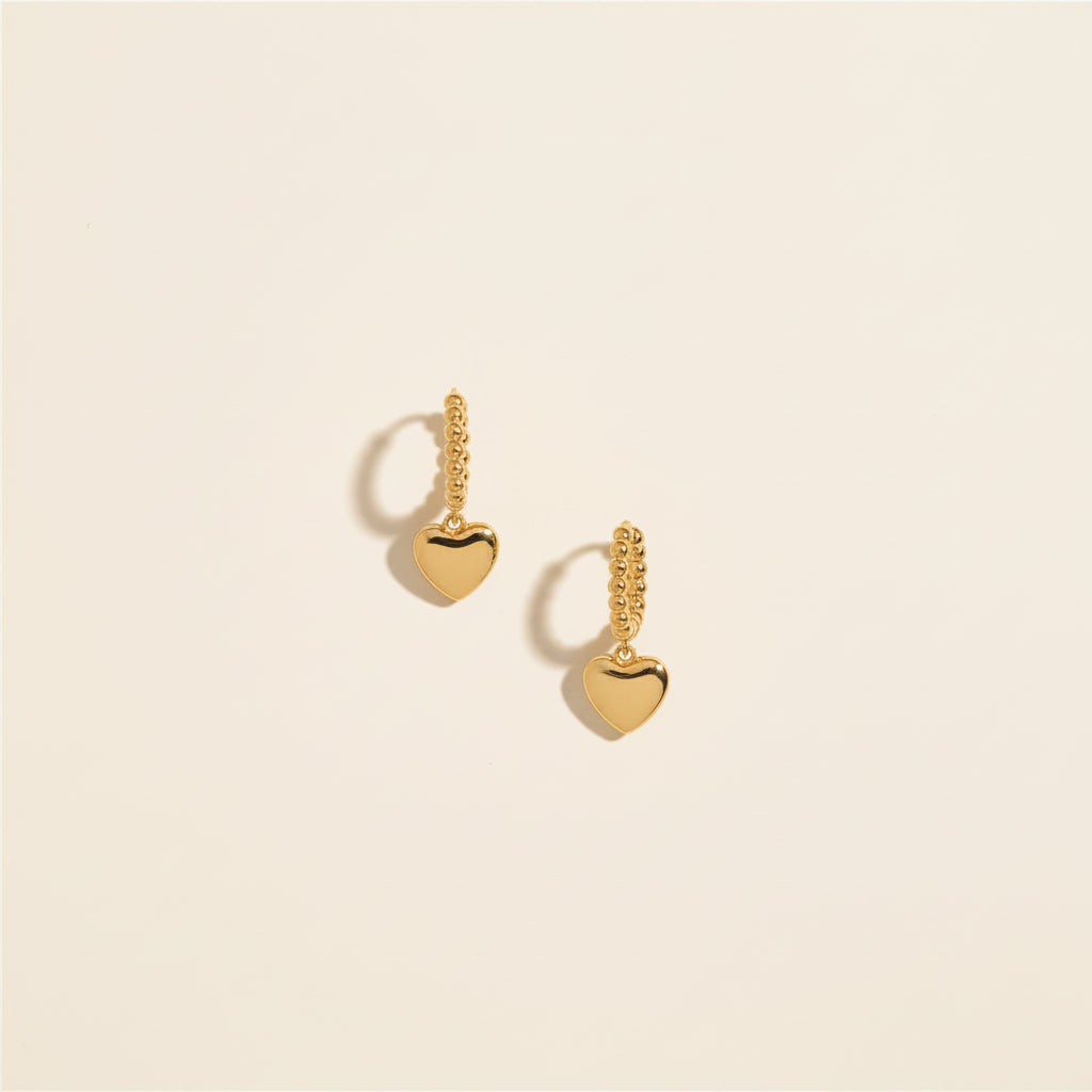 Dual Heart Charm Hoop Earrings worn on ear – romantic gold heart hoop earrings for women