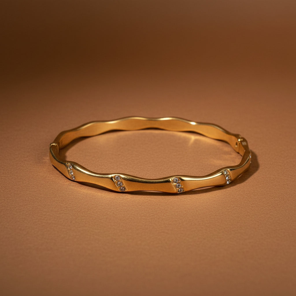Gold bracelet on a white bubble wrap background