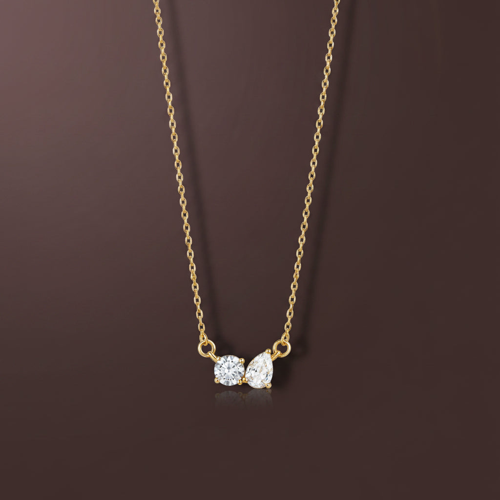 A professional high-angle flat lay catalogue shot of the gold chain with round and teardrop crystal pendant arranged in a big circle with simple shadows on a clean white background, as seen in image_9e3126.png.