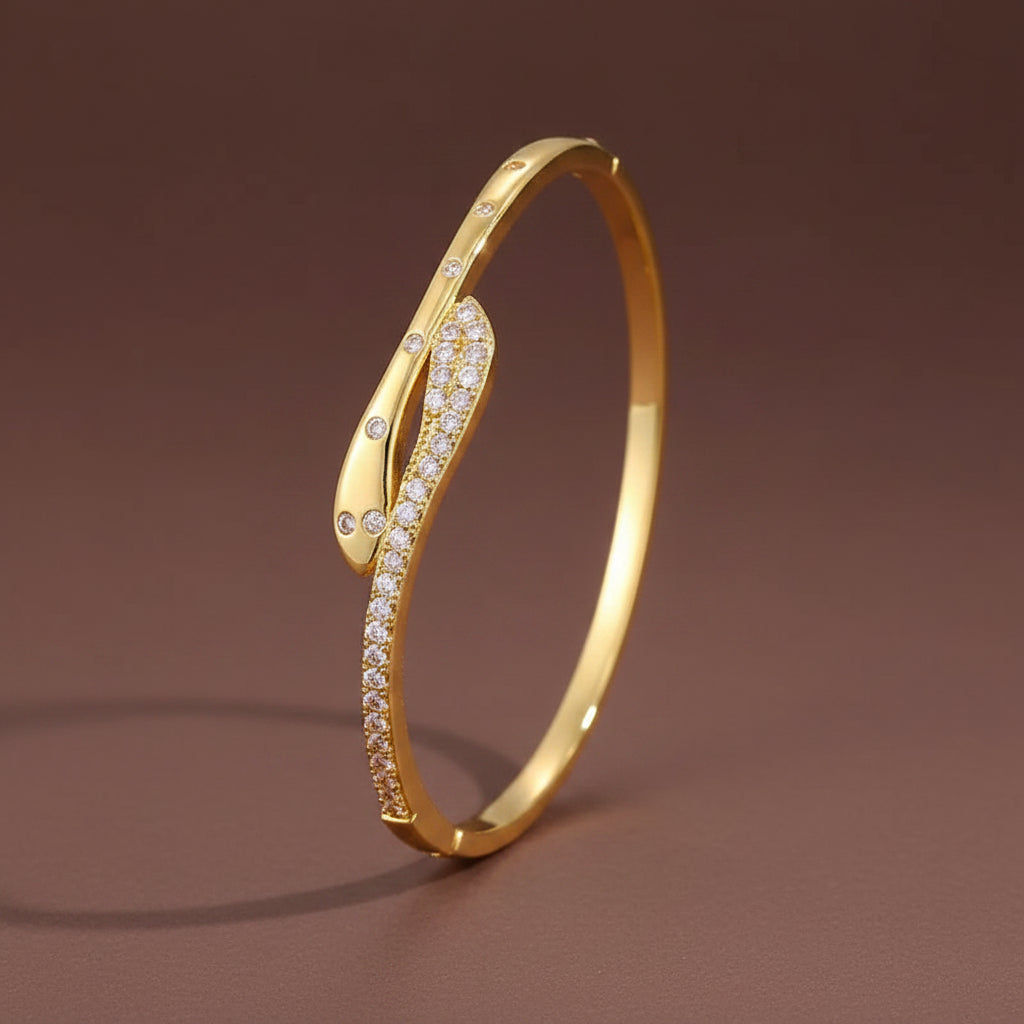 A professional high-angle flat lay catalogue shot of the gold plated snake crossover kada wrap bangle with simple shadows on a rich #5b3b3a brown background, as seen in IMG_4161.webp.