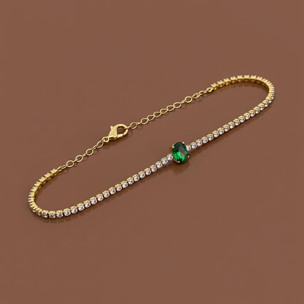 Gold bracelet with a green gemstone 