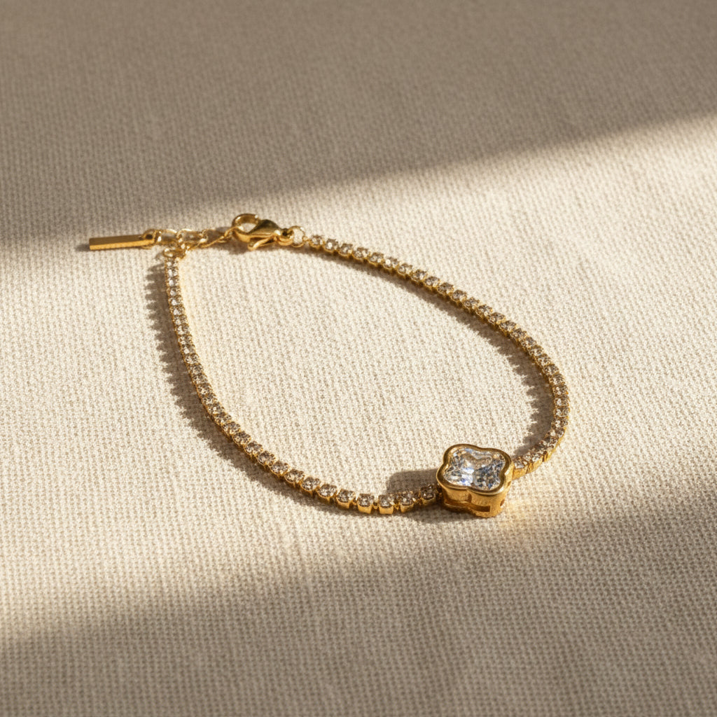 Crystal Luxe Tennis Bracelet on red fabric showing heart-shaped clasp – gold crystal bracelet for women