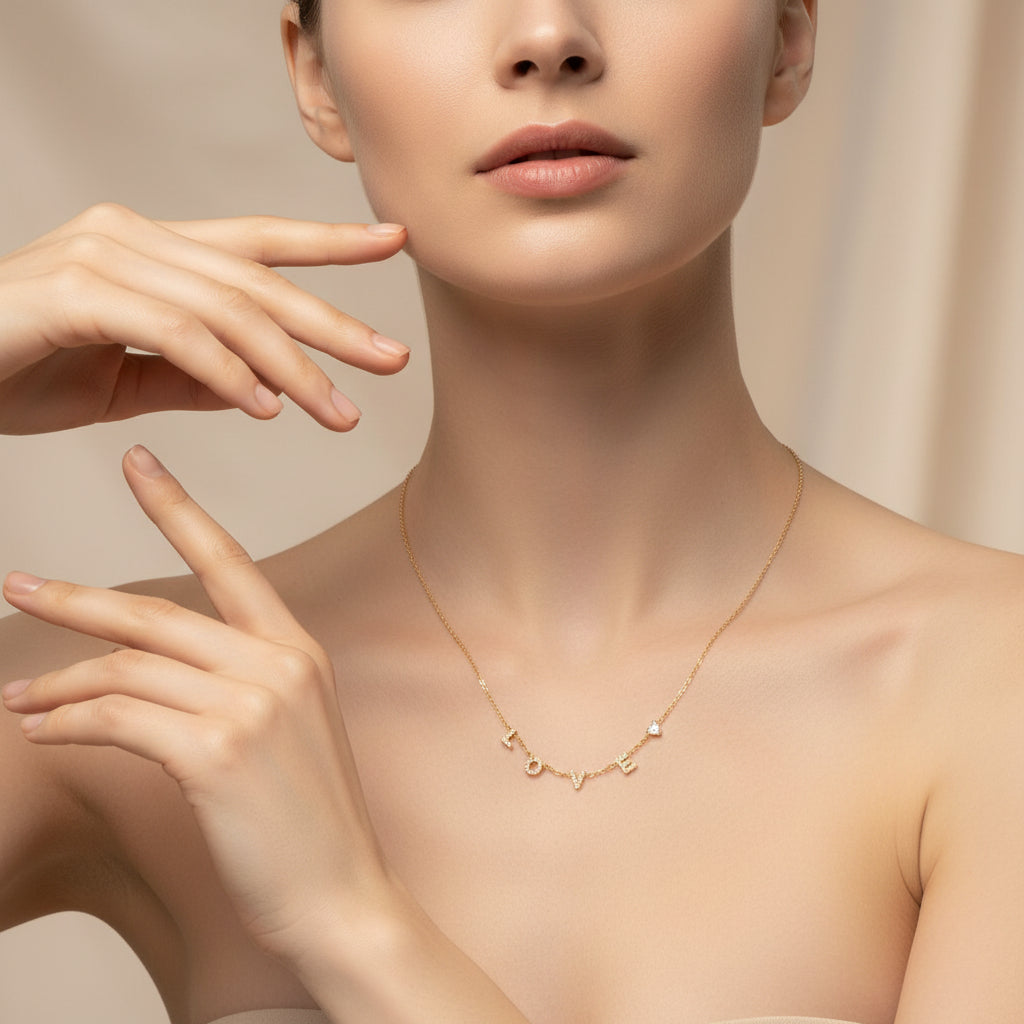 Love Luxe Necklace close-up of sparkling crystal LOVE letters and heart accent in gold setting