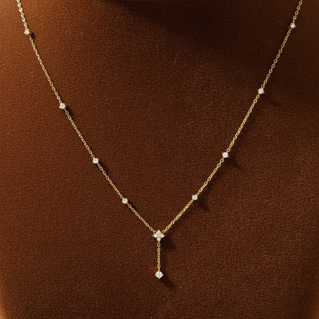 A model wearing the Elegant Drop Charm Necklace to showcase how it sits on the neckline and its refined feminine design.