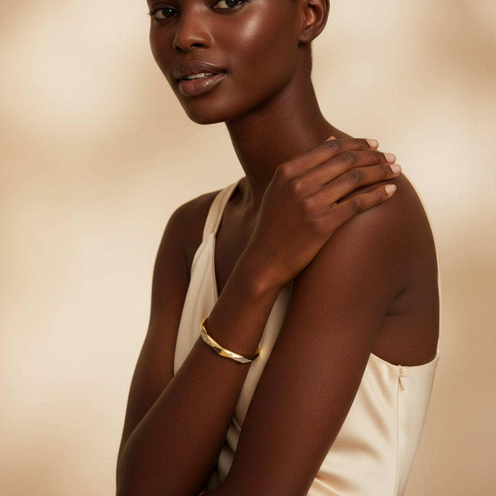 A model wearing the Celestia Twist Crystal Bangle to showcase its dynamic silhouette and radiant shimmer on the wrist.