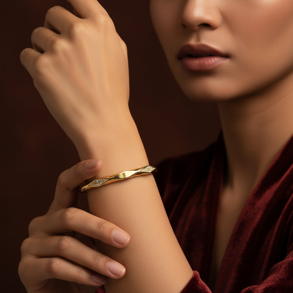 A model wearing the Celestia Twist Crystal Bangle to showcase its dynamic silhouette and radiant shimmer on the wrist.