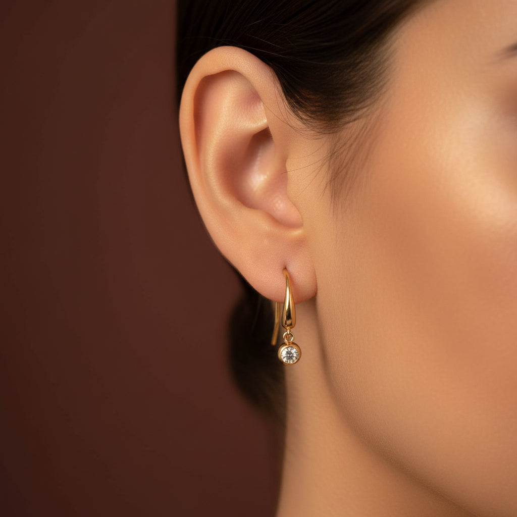 Minimal Drop Sparkle Earrings close-up of cubic zirconia crystal stone in gold plated drop setting