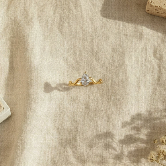 Female hand wearing the Serena Wave Pear Ring styled for an elegant everyday look.